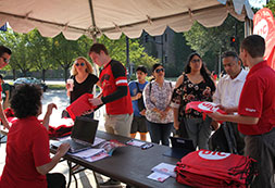 Photo of people handing out UIC tshirts. Links to Gifts of Cash, Checks, and Credit Cards