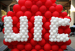 Photo of balloons that spell out UIC. Links to Gifts by Will