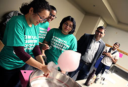 Photo of students making cotton candy. Links to What to Give