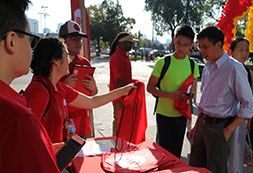 Photo of people handing out UIC tshirts. Links to Gifts That Protect Your Assets