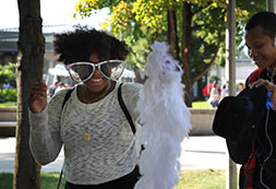 Photo of a student wearing a boa and large glasses. Links to Gifts of Life Insurance